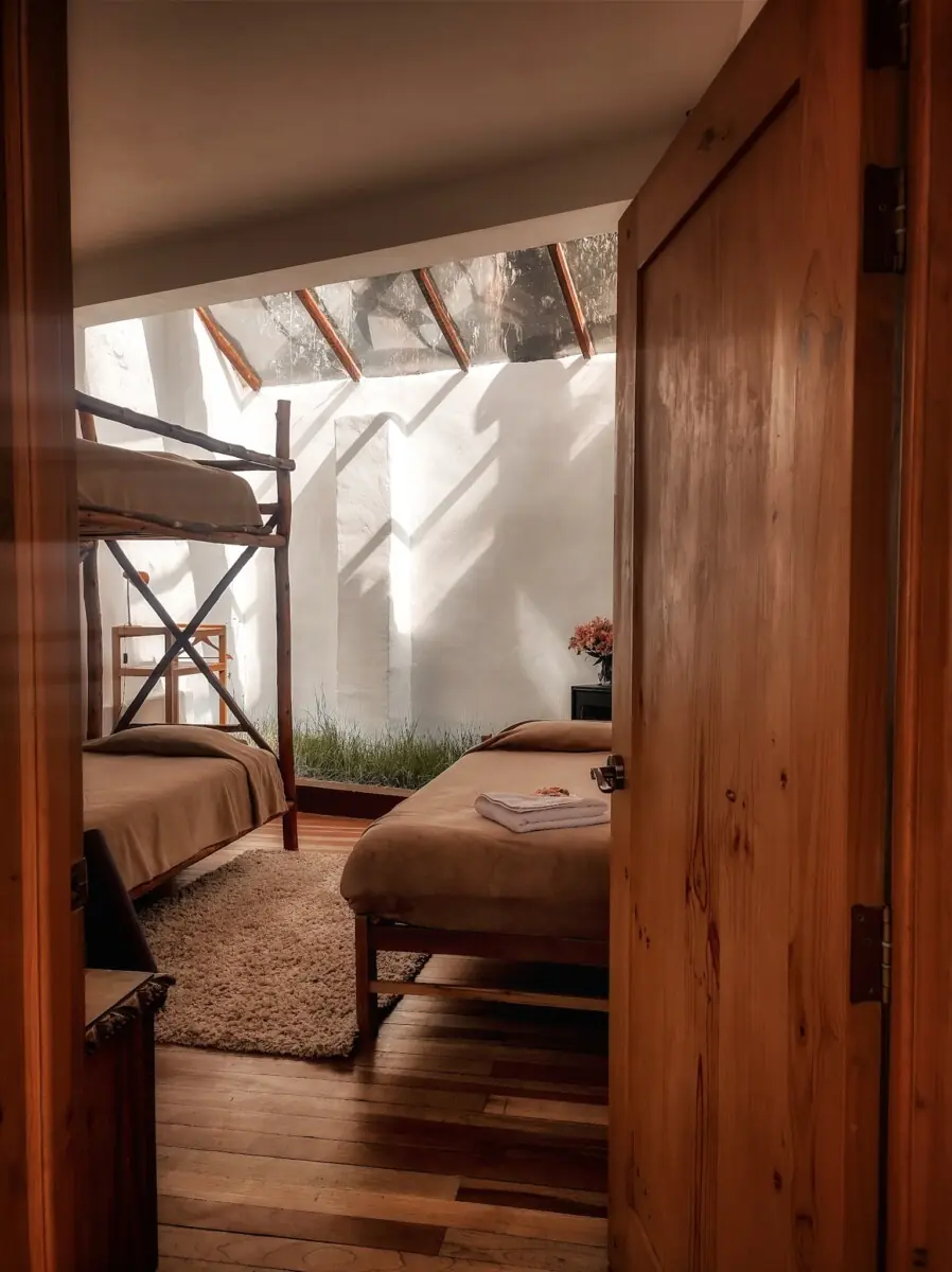 Bedroom through wooden doorway